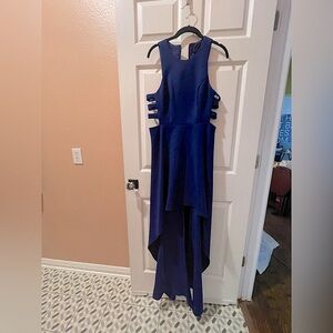 Royal blue dress with side cutouts, high neckline, and asymmetrical hemline.